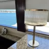 Natural Stone Dubai Table Lamp Warm Silver Leaf adorning a sleek table within a luxurious yacht interior.