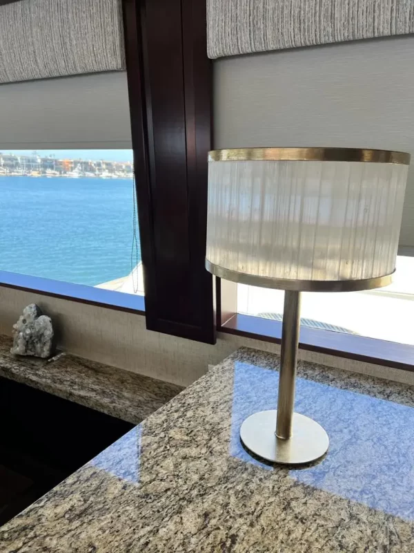 Natural Stone Dubai Table Lamp Warm Silver Leaf adorning a sleek table within a luxurious yacht interior.