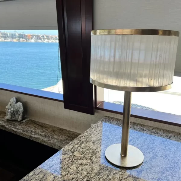 Natural Stone Dubai Table Lamp Warm Silver Leaf adorning a sleek table within a luxurious yacht interior.